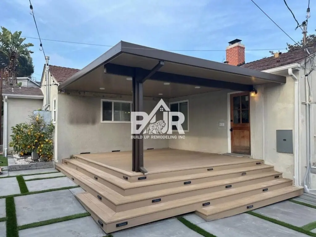 Modern backyard deck with a pergola and multi-level steps.