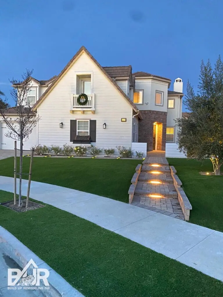 front yard of home with pavers and turf