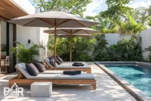 Contemporary poolside lounge area with a concrete umbrella stand and stylish gray pavers inspired by eco friendly Tulum Mexico