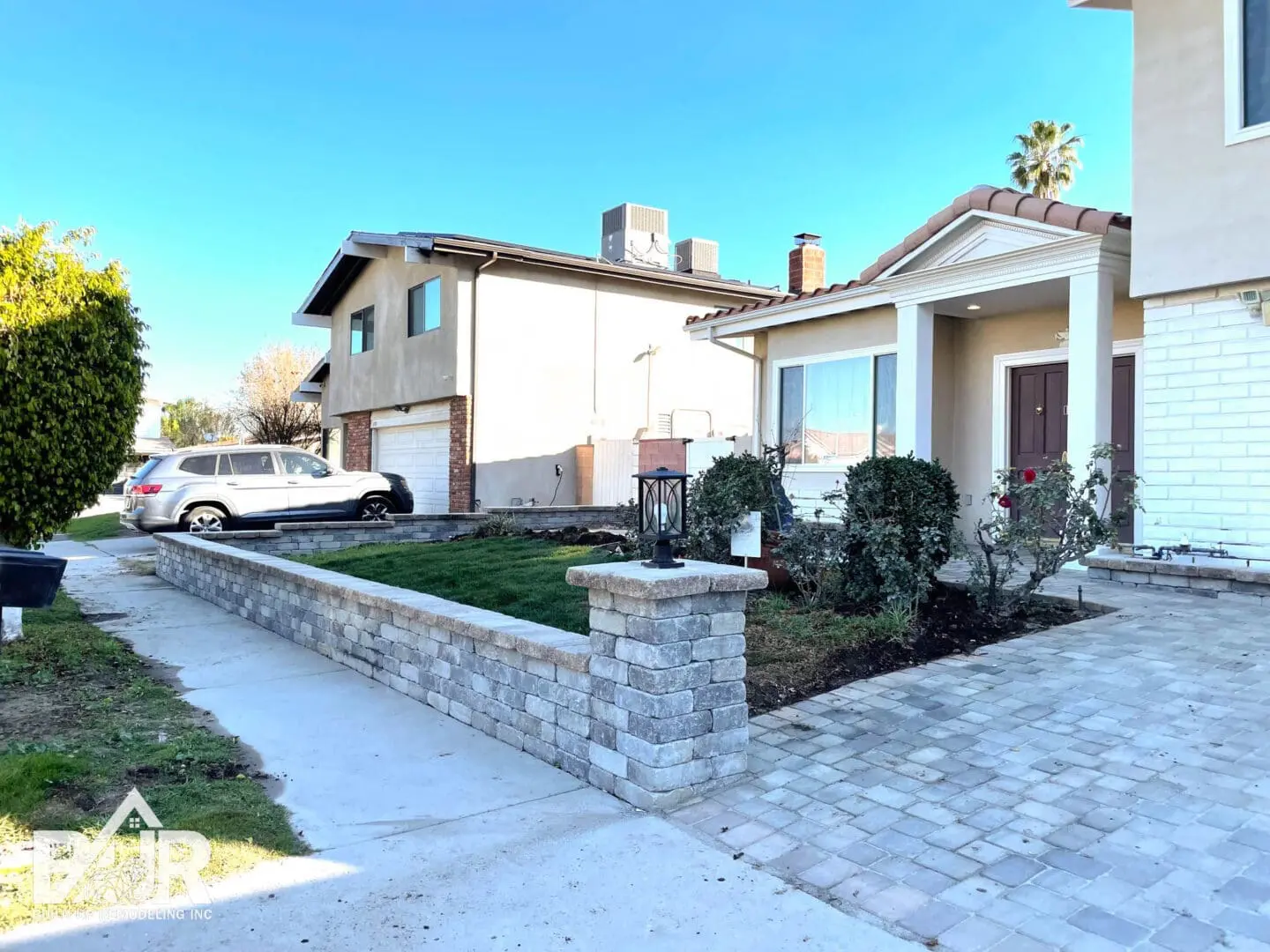 Suburban house with driveway and garden.