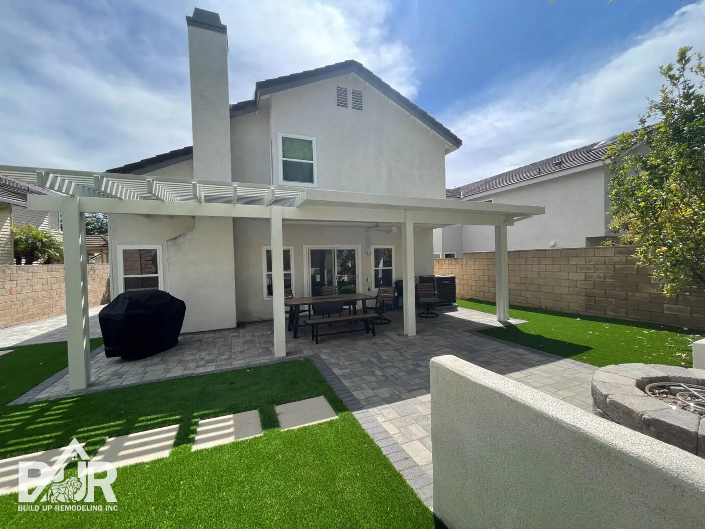 House with pergola and outdoor dining area.