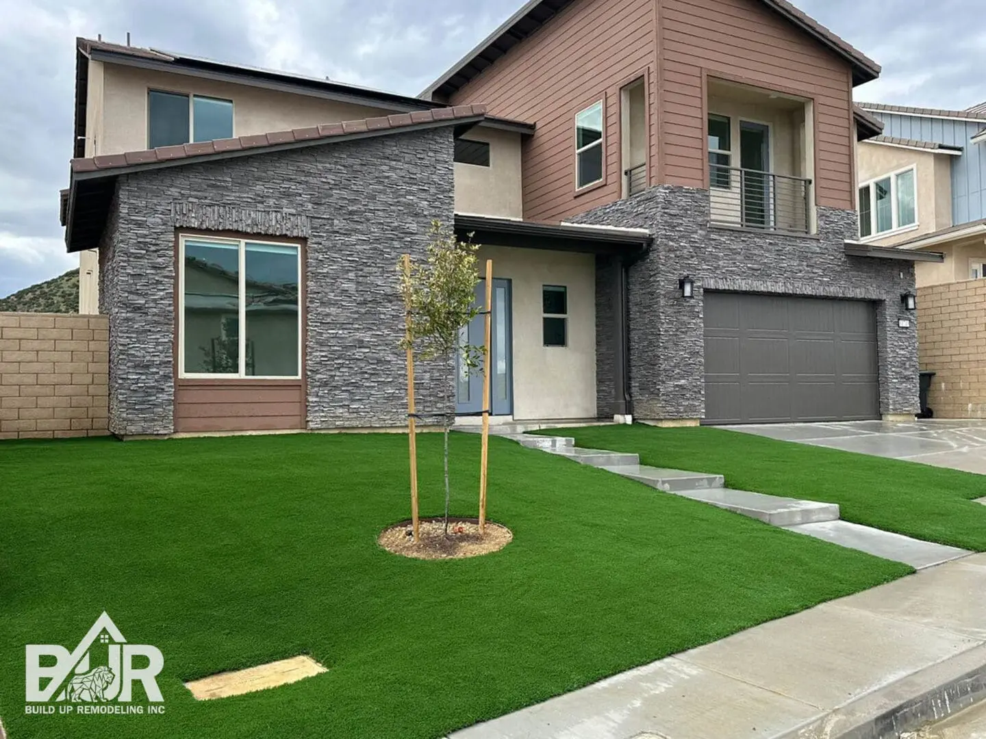 Modern house with artificial grass lawn.