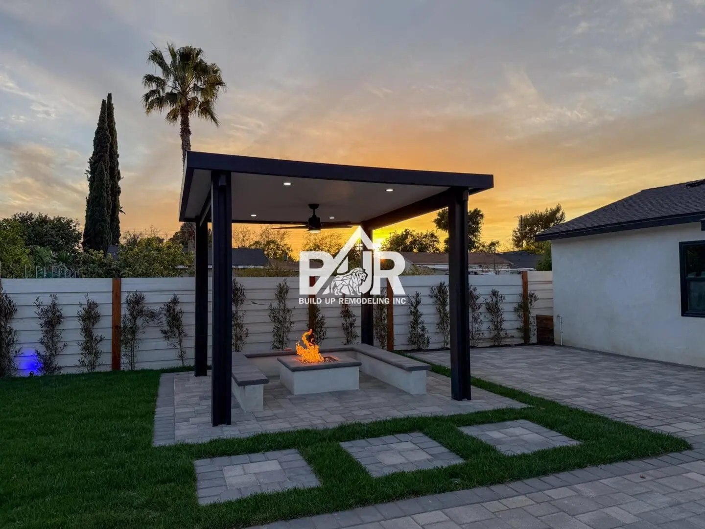 Modern patio with fire pit at sunset.