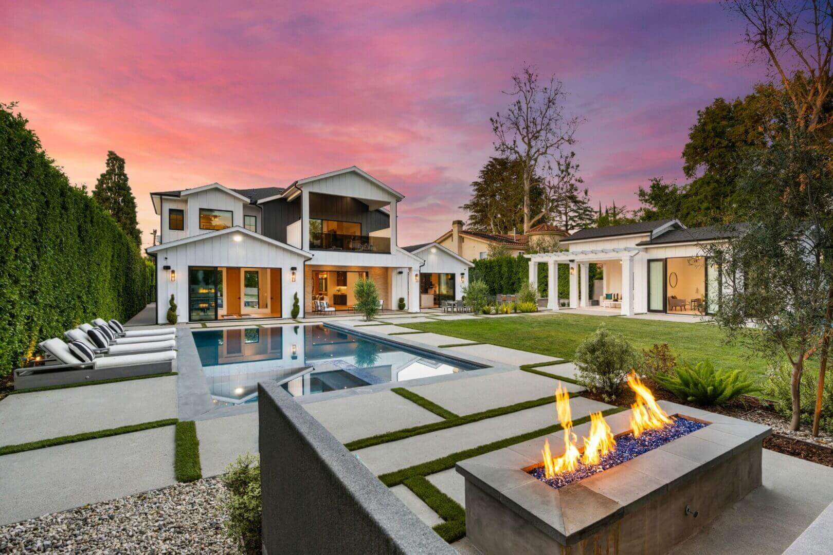 Modern house with pool and fire pit.